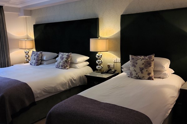 An image labelled Deluxe Triple Room