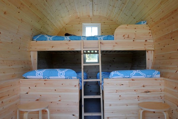An image labelled 1 Double & 1 Bunk Bed Glamping Pod